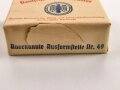 Umverpackung für "Deutsche Markenbutter" Ordentlich um ein passendes Stück Holz gefaltet