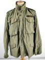 U.S.  M65 field jacket. Used, no label, size Medium. Insignia original sewn