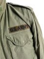 U.S.  M65 field jacket. Used, no label, size Medium. Insignia original sewn