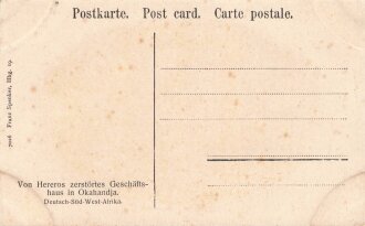 Postkarte, Deutsch Südwestafrika "Von Hereros zerstörtes Geschäftshaus in Okahandja", in den Ecken Abdrücke aus Album