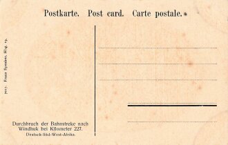 Postkarte, Deutsch Südwestafrika "Durchbruch der Bahnstrecke nach Windhuk bei Kilometer 227", in den Ecken Abdrücke aus Album