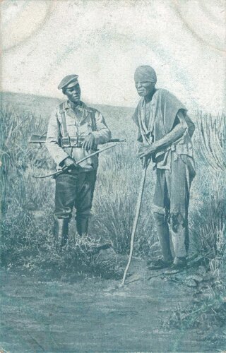 Postkarte, Deutsch Südwestafrika "Eingeborener Soldat (Bastard) mit gefangenem Herero", in den Ecken Abdrücke aus Album