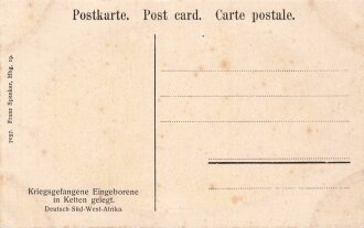 Postkarte, Deutsch Südwestafrika "Kriegsgefangene Eingeborene in Ketten gelegt", in den Ecken Abdrücke aus Album