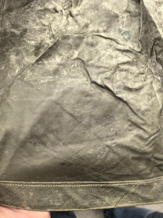 U.S. Army poncho, soft, unreadable markings. White Takum is easy to remove